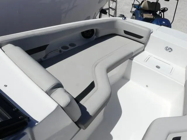 Slide: The Image of 2023 Hurricane SunDeck 235 OB boat interior with cushioned seating and cup holders. - 16