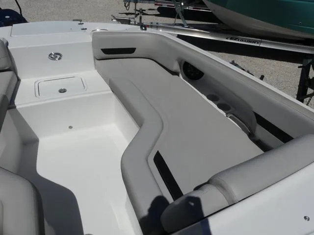 Slide: The Image of 2023 Hurricane SunDeck 235 OB boat interior with gray seating and storage compartments. - 17