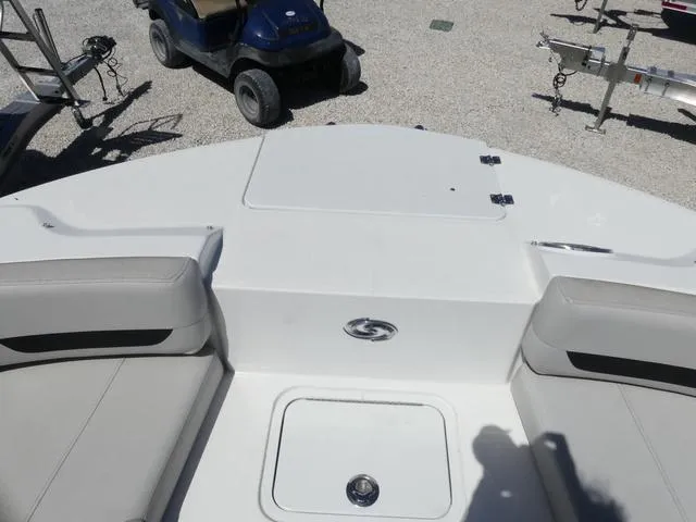 Slide: The Image of 2023 Hurricane SunDeck 235 OB boat interior with seating and storage compartments. - 18