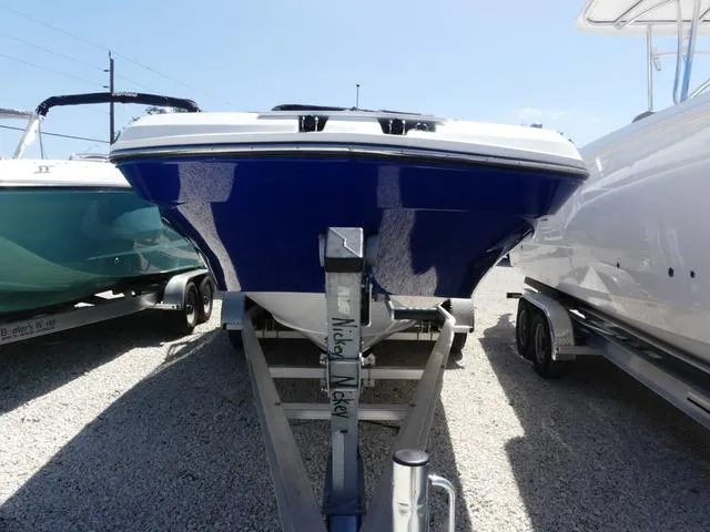 Slide: The Image of 2023 Hurricane SunDeck 235 OB boat on trailer, blue hull, parked outdoors. - 2