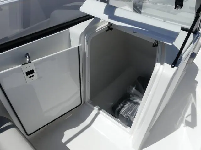 Slide: The Image of 2023 Hurricane SunDeck 235 OB storage compartment with open hatch, showcasing interior space. - 20