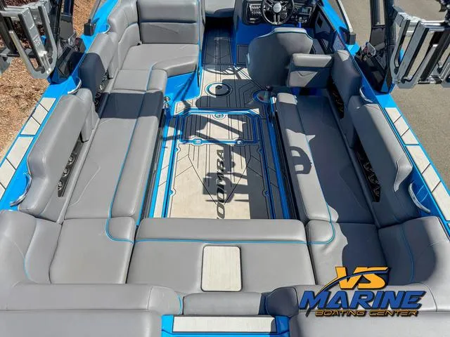 Slide: The Image of 2022 Moomba Makai boat interior with gray seating and blue accents, featuring VS Marine logo. - 11