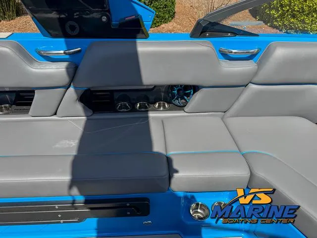 Slide: The Image of 2022 Moomba Makai boat interior with gray seating and blue accents at VS Marine Boating Center. - 13