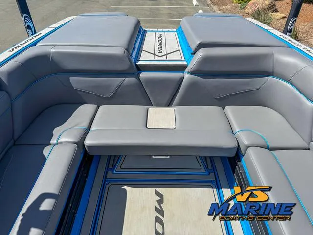 Slide: The Image of 2022 Moomba Makai boat interior with gray seating and blue accents at VS Marine Boating Center. - 15
