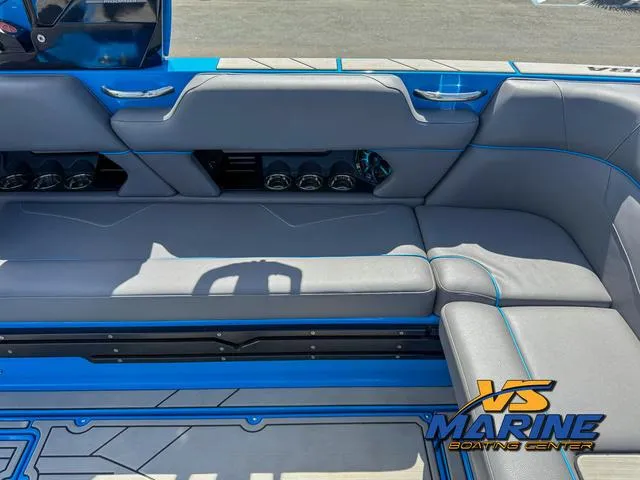 Slide: The Image of 2022 Moomba Makai boat interior with gray seating and blue accents at VS Marine Boating Center. - 16