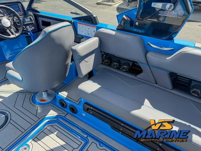 Slide: The Image of 2022 Moomba Makai boat interior with blue and gray seating, dashboard, and VS Marine logo. - 17