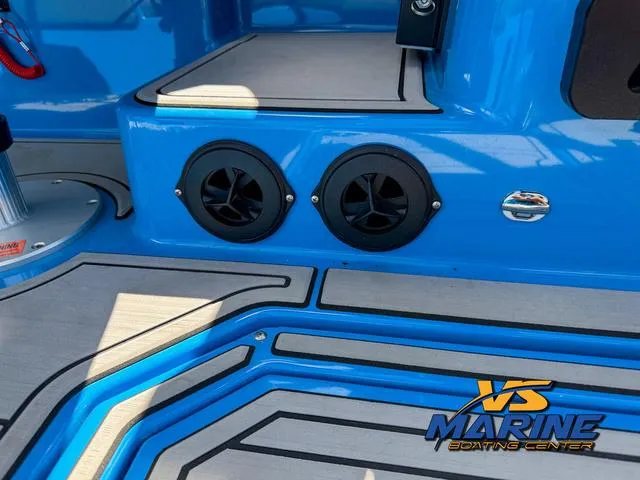 Slide: The Image of 2022 Moomba Makai boat interior with blue accents and dual speakers. - 18