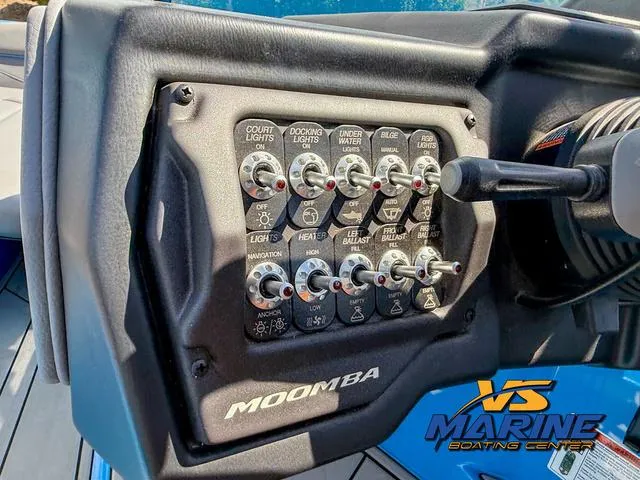 Slide: The Image of Control panel of 2022 Moomba Makai boat with various switches and labels. - 23