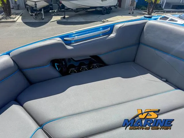 Slide: The Image of 2022 Moomba Makai boat interior with gray seating and blue accents at VS Marine Boating Center. - 25