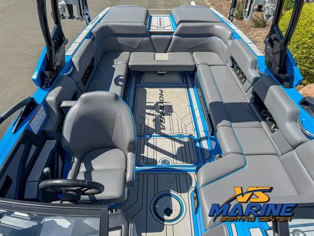 Slide: The Image of 2022 Moomba Makai boat interior with gray seating and blue accents at VS Marine Boating Center. - 26