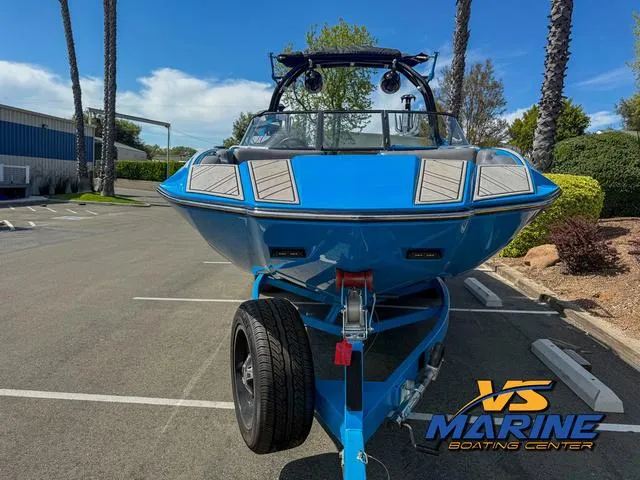 Slide: The Image of 2022 Moomba Makai boat in a parking lot, vibrant blue color, front view. - 3