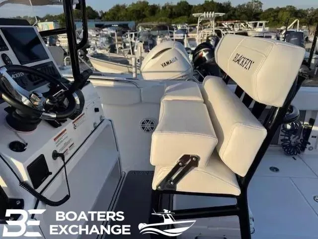 Slide: The Image of 2020 Blackfin 242CC boat interior with Yamaha engine, featuring helm and seating. - 6