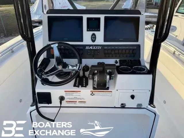 Slide: The Image of 2020 Blackfin 242CC boat dashboard with dual screens and steering wheel. - 7