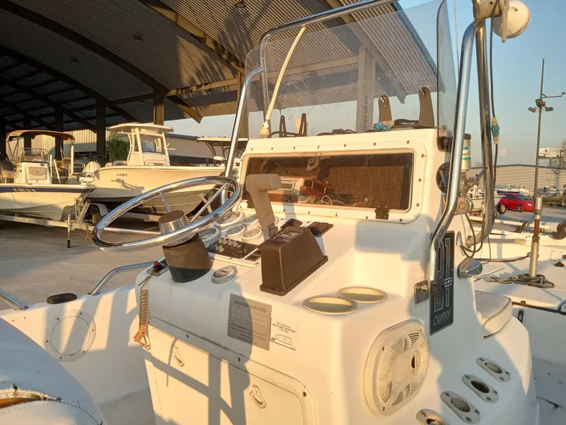 Slide: The Image of 2000 Champion 21 Bay Champ boat interior with steering wheel and control panel. - 6