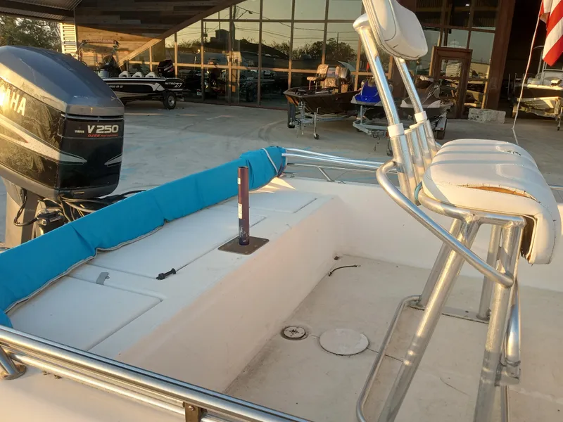 Slide: The Image of 2000 Champion 21 Bay Champ boat with Yamaha V250 engine, docked outdoors. - 8