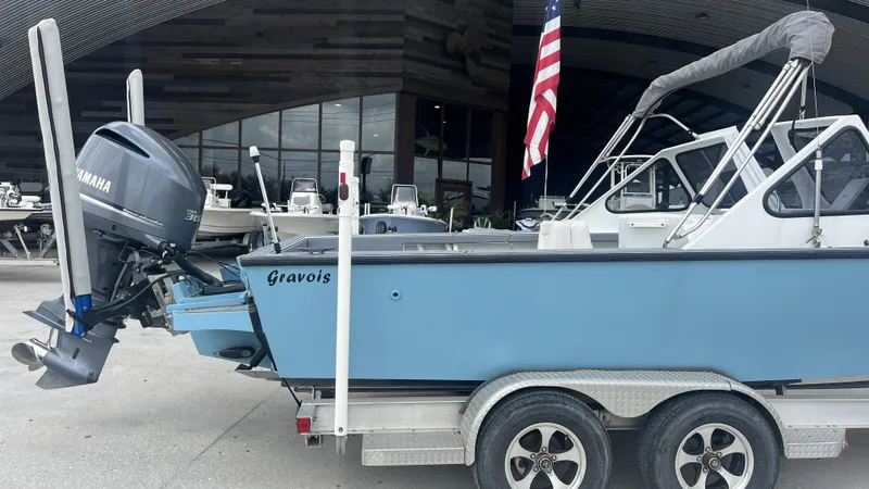 Slide: The Image of Gravois 22' Dual Console Hybrid boat, 2000 model, with Yamaha motor on trailer. - 14