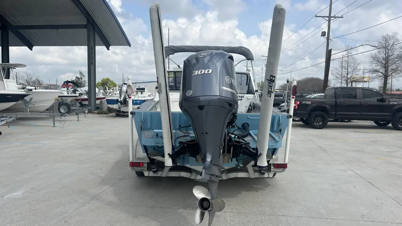 Slide: The Image of 2000 Gravois 22' Dual Console Hybrid boat with powerful 300 engine, parked outdoors. - 18