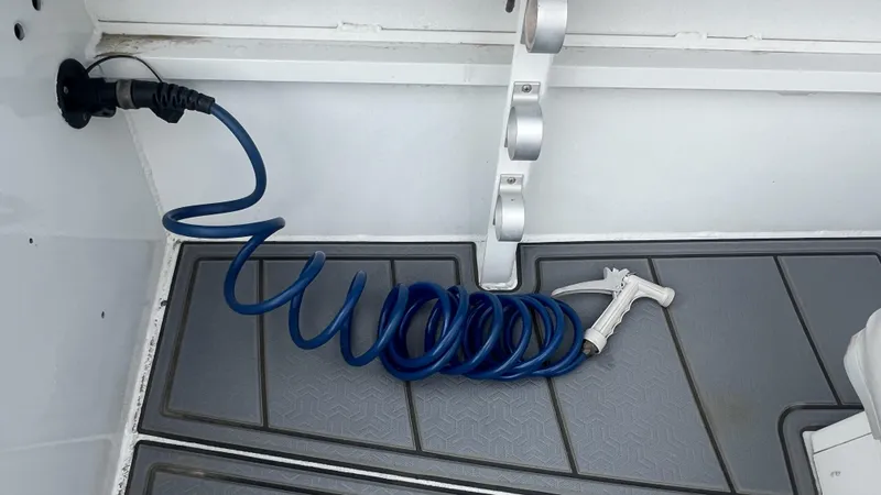 Slide: The Image of Coiled blue hose on Gravois 22' Dual Console Hybrid boat deck, 2000 model. - 20