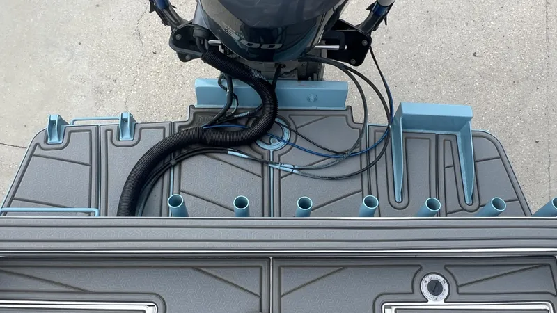 Slide: The Image of Gravois 22' Dual Console Hybrid boat deck with motor, 2000 model, featuring rod holders. - 3