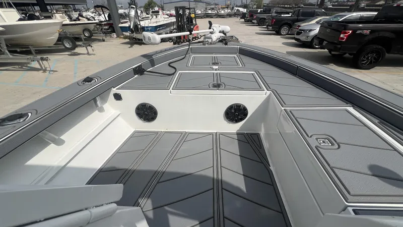 Slide: The Image of 2000 Gravois 22' Dual Console Hybrid boat interior with gray seating and storage compartments. - 8