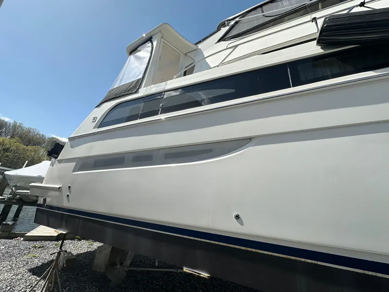 Slide: The Image of 2007 Carver 43 Motor Yacht side view under clear blue sky. - 13