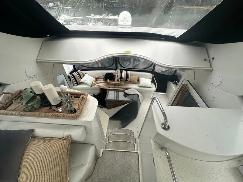 Slide: The Image of 2007 Carver 43 Motor Yacht interior with cozy seating and decorative accents. - 14