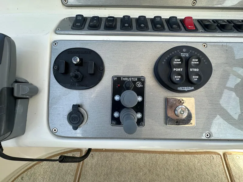 Slide: The Image of Control panel of a 2007 Carver 43 Motor Yacht with various switches and dials. - 16