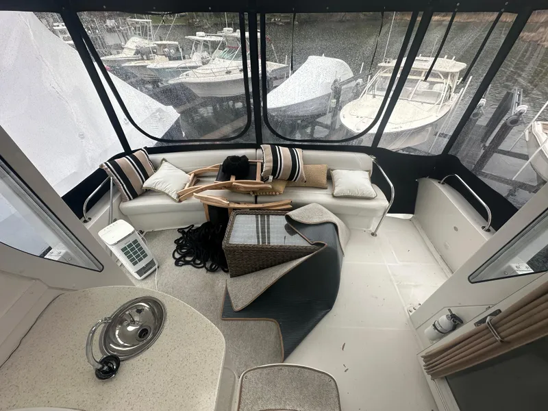 Slide: The Image of Interior of 2007 Carver 43 Motor Yacht with seating and marina view. - 19