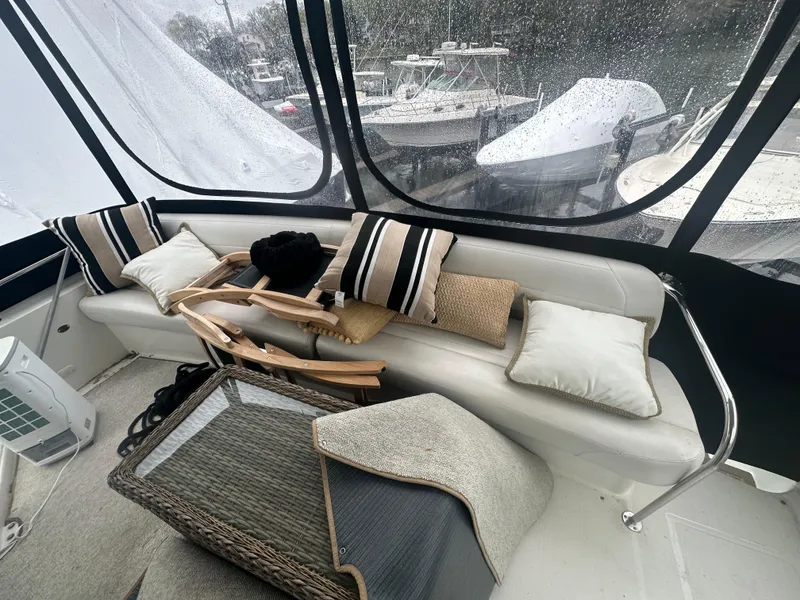 Slide: The Image of Cozy seating area on 2007 Carver 43 Motor Yacht with cushions and wicker table. - 22