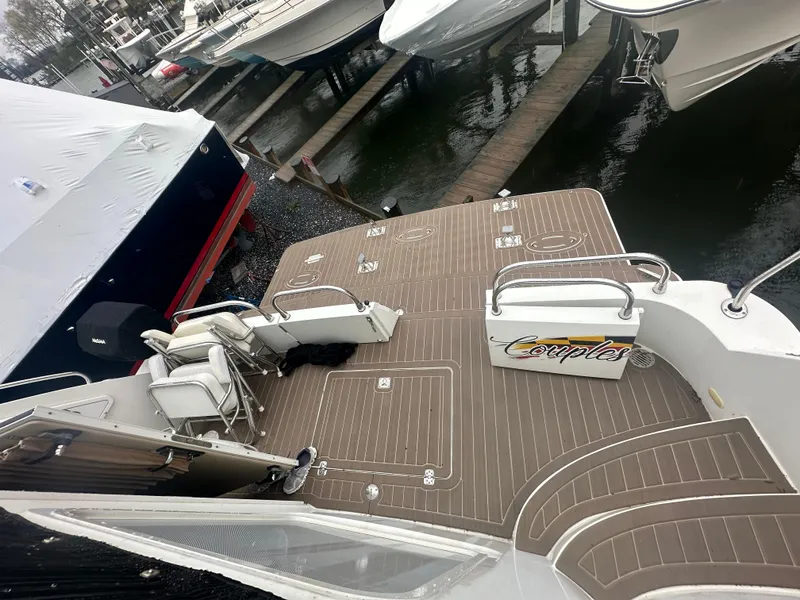 Slide: The Image of 2007 Carver 43 Motor Yacht docked, featuring spacious deck and seating area. - 23