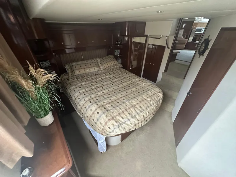 Slide: The Image of Luxurious bedroom interior of 2007 Carver 43 Motor Yacht with cozy bedding and elegant decor. - 24