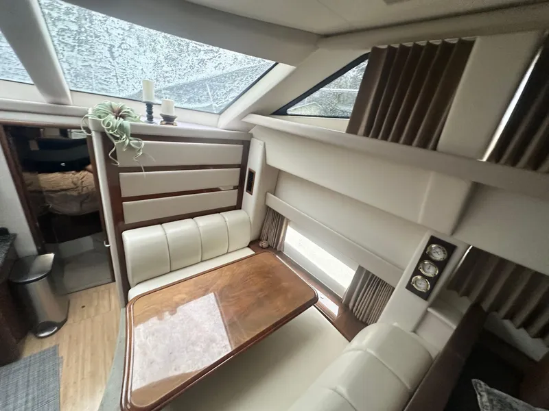 Slide: The Image of Interior of 2007 Carver 43 Motor Yacht with elegant dining area and natural light. - 27