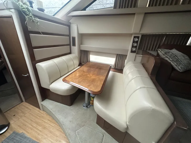 Slide: The Image of Interior of 2007 Carver 43 Motor Yacht with dining area and plush seating. - 28