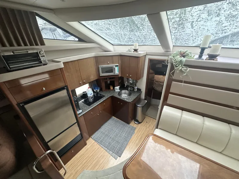 Slide: The Image of Interior of 2007 Carver 43 Motor Yacht with modern kitchen and seating area. - 31