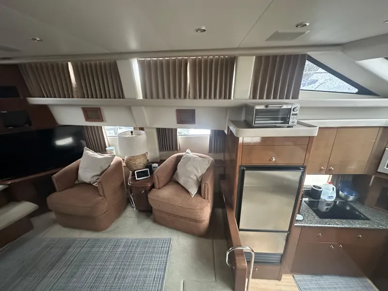 Slide: The Image of Interior of 2007 Carver 43 Motor Yacht with cozy seating and modern kitchen amenities. - 32