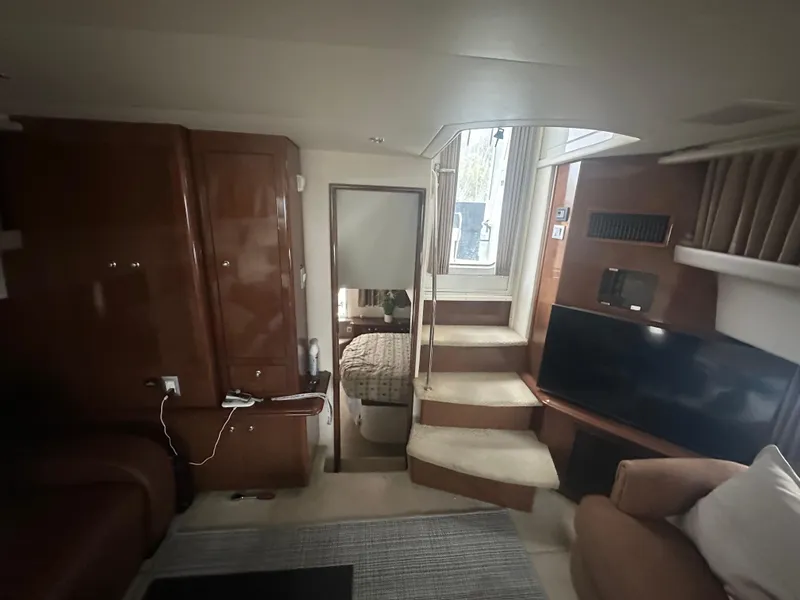 Slide: The Image of Interior of 2007 Carver 43 Motor Yacht with stairs, TV, and cozy seating area. - 33