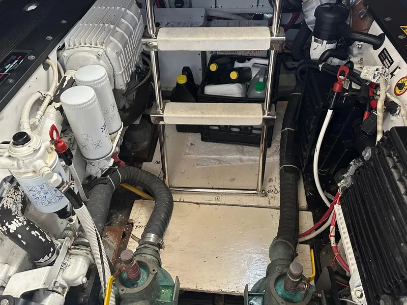 Slide: The Image of Engine room of a 2007 Carver 43 Motor Yacht with visible components and maintenance supplies. - 49