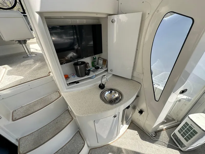 Slide: The Image of 2007 Carver 43 Motor Yacht interior with sink, TV, and stairs. - 50