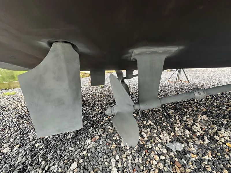 Slide: The Image of Underside view of 2007 Carver 43 Motor Yacht propeller and rudder on gravel. - 52