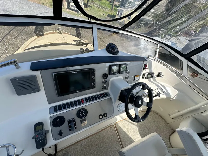 Slide: The Image of 2007 Carver 43 Motor Yacht helm with navigation equipment and steering wheel. - 8
