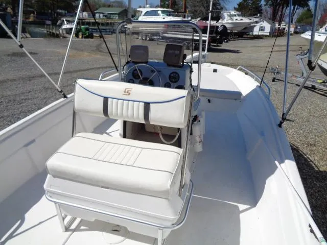 Slide: The Image of 2005 Sea Chaser 1800 RG boat interior with white seating and steering console. - 13