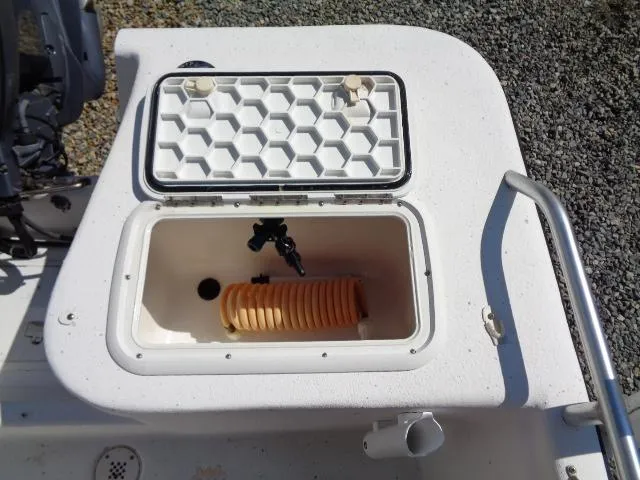 Slide: The Image of 2005 Sea Chaser 1800 RG boat compartment with open hatch and coiled hose. - 8