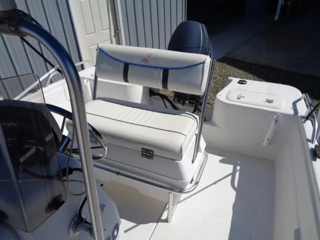 Slide: The Image of 2005 Sea Chaser 1800 RG boat interior with white seating and steering console. - 9