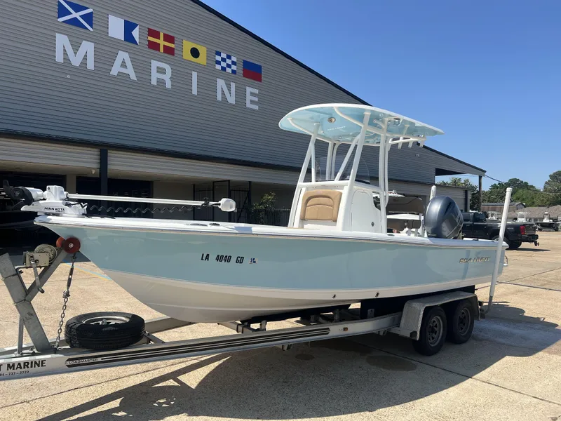 Slide: The Image of 2015 Sea Hunt BX 22 BR boat on trailer outside marine store. - 2