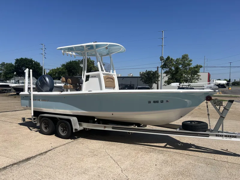 Slide: The Image of 2015 Sea Hunt BX 22 BR boat on trailer, parked outdoors under clear blue sky. - 5