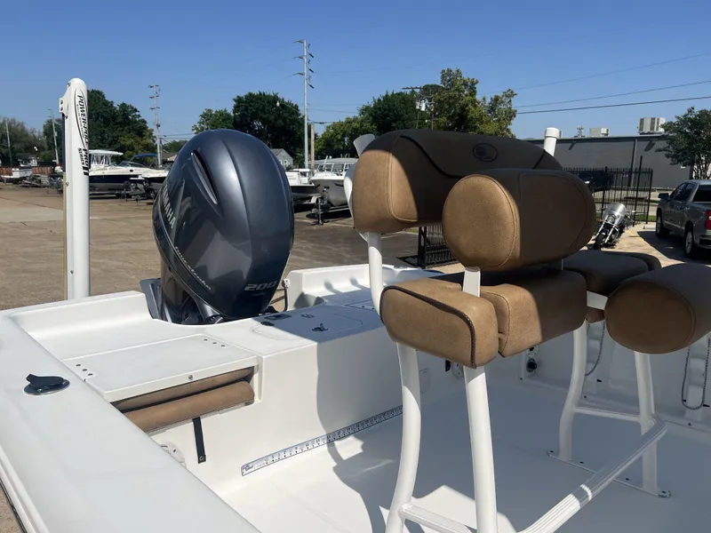 Slide: The Image of 2015 Sea Hunt BX 22 BR boat with Yamaha engine and tan seating, parked outdoors. - 6