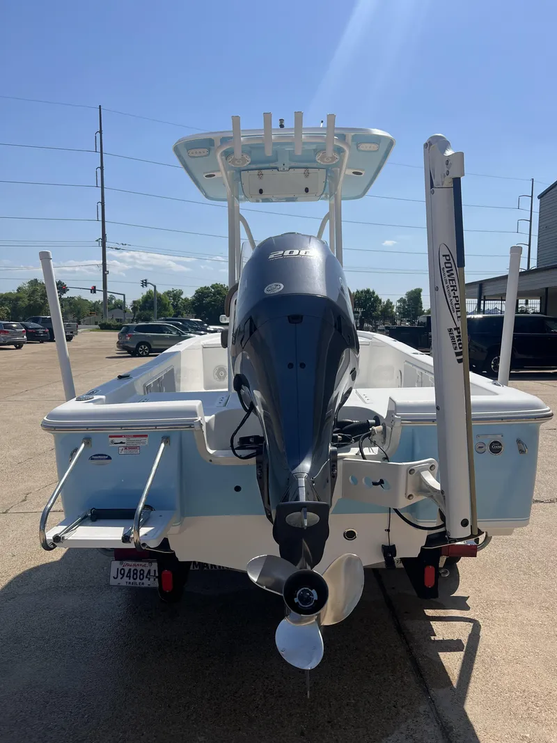Slide: The Image of 2015 Sea Hunt BX 22 BR boat with Yamaha outboard motor, parked outdoors. - 9