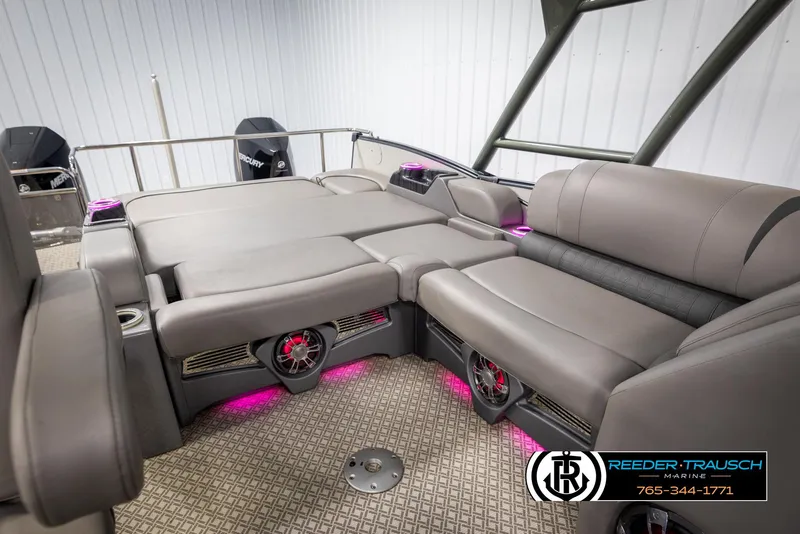 Slide: The Image of 2022 Avalon Catalina VRB boat interior with gray seating and pink LED lighting. - 23