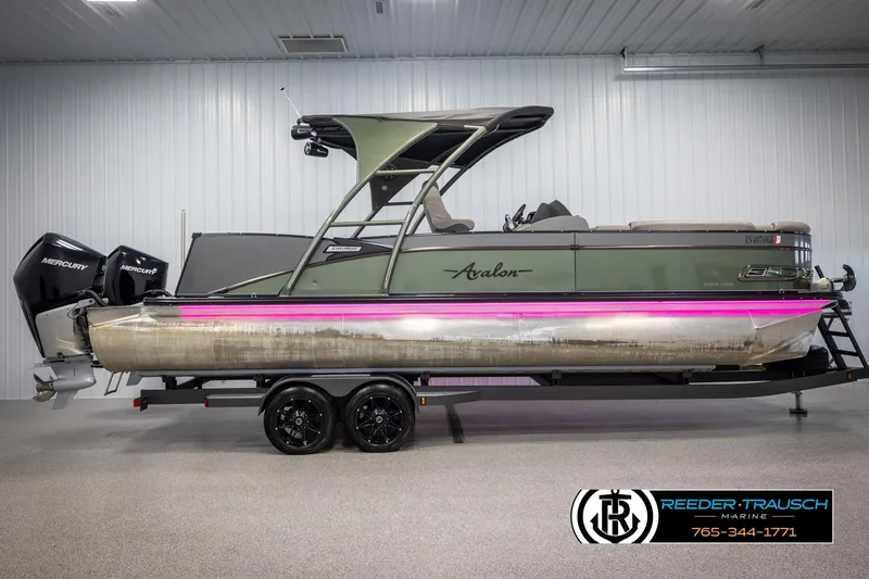 Slide: The Image of 2022 Avalon Catalina VRB pontoon boat with dual Mercury engines in a showroom. - 4