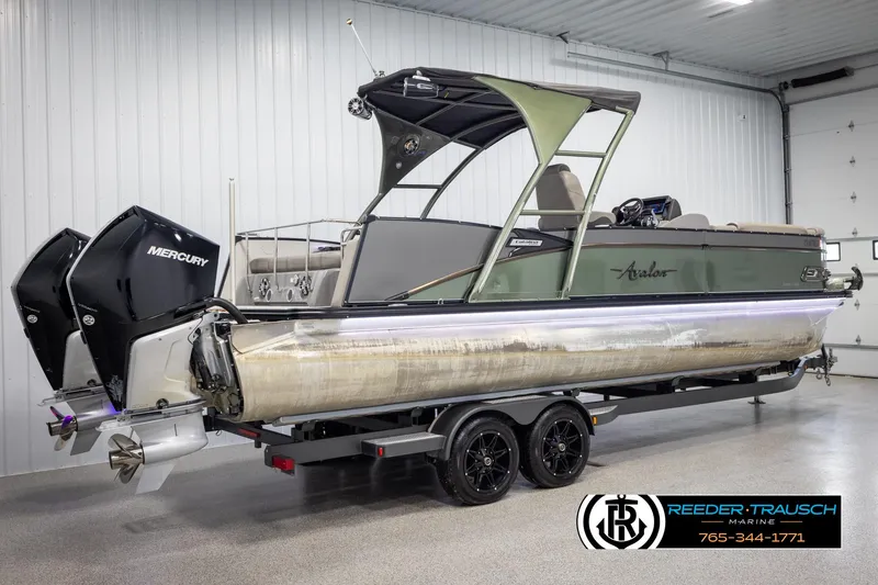 Slide: The Image of 2022 Avalon Catalina VRB pontoon boat with dual Mercury engines in a showroom. - 5